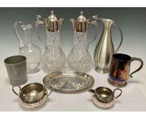 Silver Plate &amp; Glass - A pair of cut glass claret jugs mounted with EPNS collar and lid, C-scroll handles, mask spouts, 3