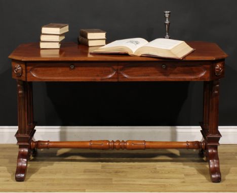 A Post-Regency Gothic Revival mahogany library table, canted rectangular top with moulded edge above a pair of frieze drawers