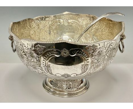 A large silver plated pedestal punch bowl, embossed with foliate scrolls, pair of lion mask loop handles, 33cm diameter, with