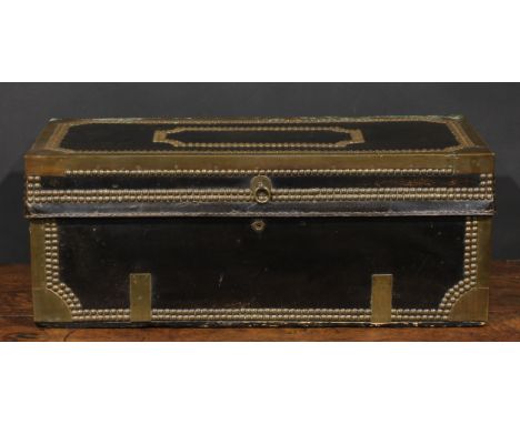 An early 19th century brass and studded leather mounted camphor travelling or coaching trunk, hinged top, carry handles to si