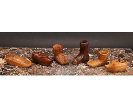 An early 20th century treen snuff box, carved as a shoe, 9cm wide; another similar; a Continental treen vesta holder, carved 