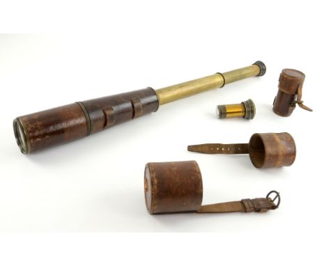  Brass three-draw telescope, the sliding lens shade and body with leather covering; together with a substitute ocular lens (m