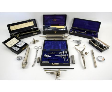 Collection of mid-20th century scientific instruments, including cased diagnostic sets, ear syringe and fixed arm planimeters