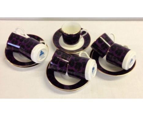 7 Enzart Designs coffee cans and saucers with purple & black decoration.