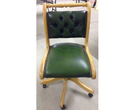 Light wood study chair with studded green leather upholstery.