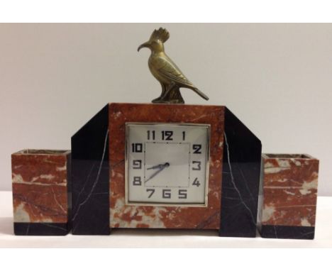 An Art Deco marble mantle clock with gilt bird finial and marble garnitures. Clock in working order.