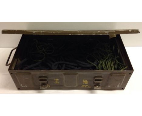 A brown military ammunition box containing a quantity of cordage and rope.