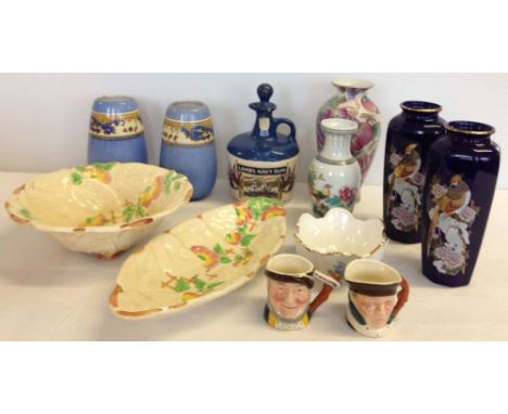A box of assorted china to include Lamb's Navy Rum decanter & 2 Lancaster small character jugs.