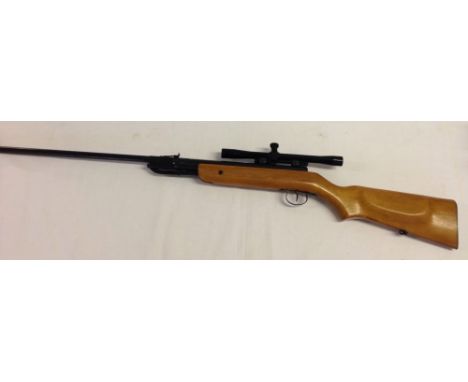 An Air riffle with light wood stock & sight.