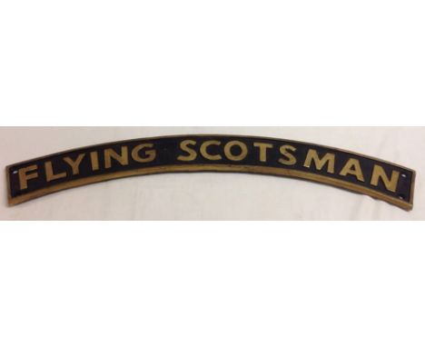 A reproduction cast iron 'Flying Scotsman' curved steam engine name plate, 90cm long.
