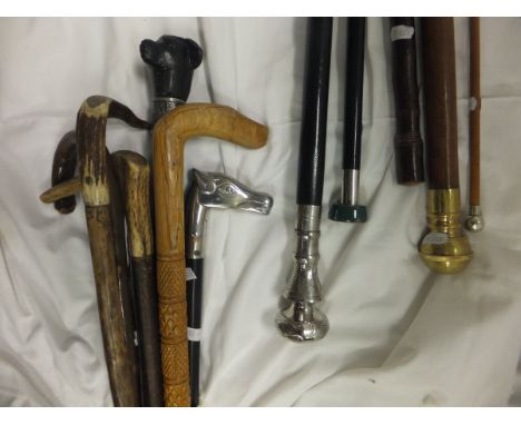 Twelve assorted walking sticks and swagger sticks to include an example with hidden pipe to handle, the swagger stick with ha