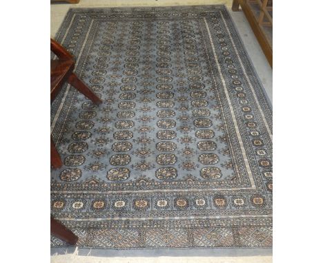 A Belouch carpet, the central panel with repeating elephant foot medallions on a blue / grey ground within multiple borders d