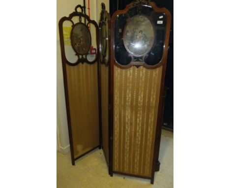 An Edwardian mahogany and inlaid threefold dressing screen, the glazed upper section inset with figural engraving panels COND