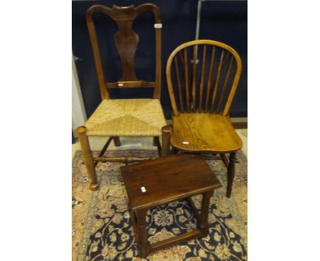 A yew wood splat back rush seated chair, the front leg stamped "BG", together with an elm stick back kitchen chair and a yew 