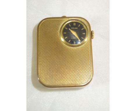 A gilt cased musical clock with engine turned decoration, signed "Reuge" and inscribed "17 Jewels Incabloc"