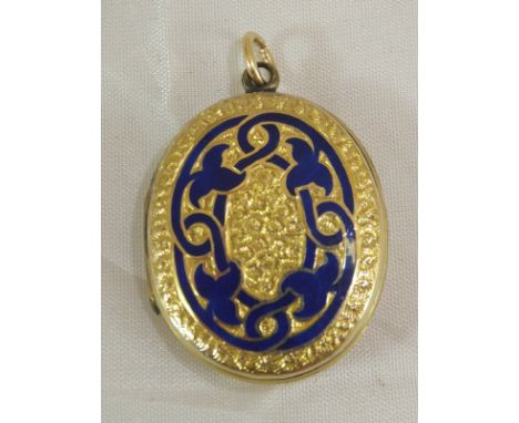 A Victorian un-marked yellow metal and blue enamel decorated locket