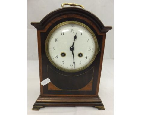 A mahogany cased mantel clock with Arabic numerals to the enamel dial