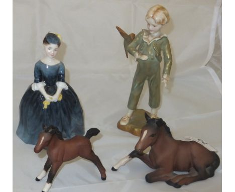 A Royal Worcester figure "The Parakeet", model No. 3087, modelled by F G Doughty, together with two Beswick pottery foals and
