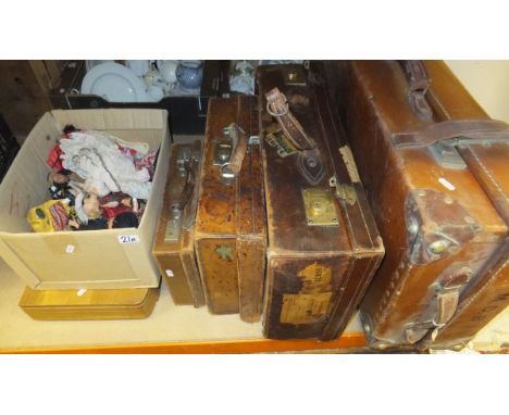Four various vintage leather suitcases, a box of vintage national costume dolls and a cased canteen of cutlery