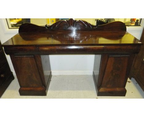 A late Regency/William IV mahogany pedestal sideboard, the raised foliate decorated back over three cushion drawers on two ar