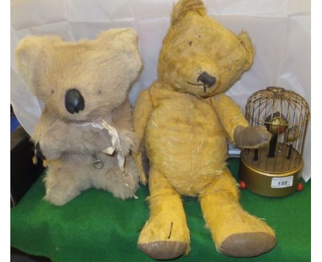 A vintage mohair teddy bear with jointed limbs, a vintage koala bear soft toy, and a Precision Watch Co Ltd automaton of bird