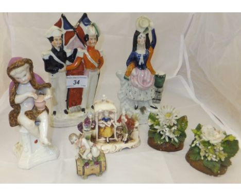 A small collection of pottery and ceramic ornaments to include a miniature Continental pottery figure of a cherub upon a barr