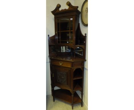 An Edwardian mahogany corner display cabinet, the mirrored superstructure with glazed cupboard door and swan neck pediment ov