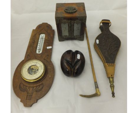 A pair of oak bellows with carved thistle decoration, a treen ware ornament in the form of Coco de Mer, oak barometer, iron l