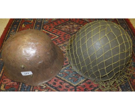 A German military helmet, together with an American GI helmet