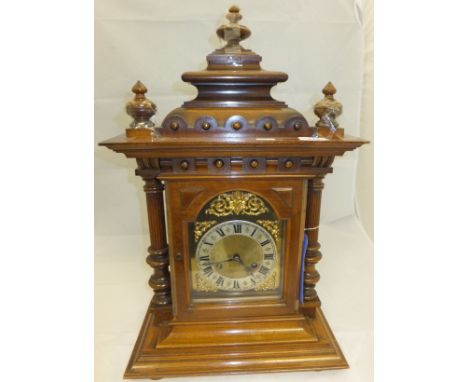 A circa 1900 walnut bracket clock, the brass dial with silver chapter ring, Arabic numerals with scrolling spandrels and cher