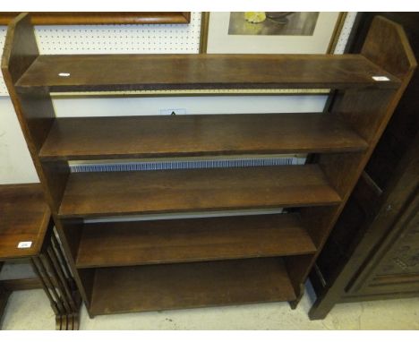 An oak Arts and Crafts style bookcase CONDITION REPORTS Wear, scuffs, stains, chips.  Large split to right side.  Approx 103c