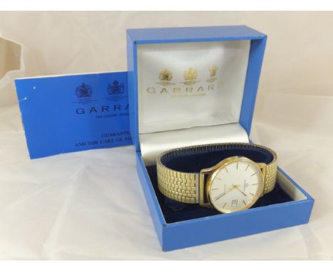 A Garrard wristwatch, the brushed dial set with numeral markers and date marker, inscribed verso "Cornwall Parker 25 Club Mr 