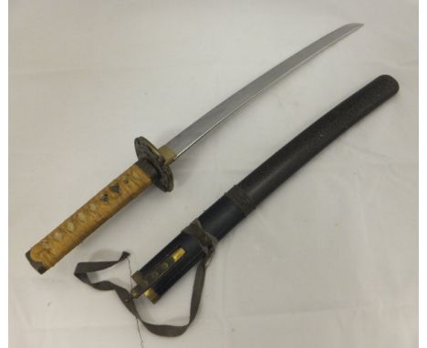 A Japanese Wakizashi with cloth bound shagreen effect handle CONDITION REPORTS Wear, scuffs, some losses.  Blade and grip is 