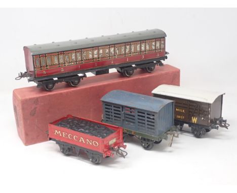A boxed Hornby 0 gauge No.2 LMS 1st/3rd Passenger Coach, an unboxed NE Cattle Van, Meccano Coal Wagon and GW Milk Van 