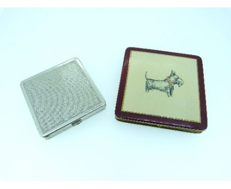 Two Powder Compacts, one in gilt metal the top with read enamel border, white centre and a Scottie Dog, the other smaller in 