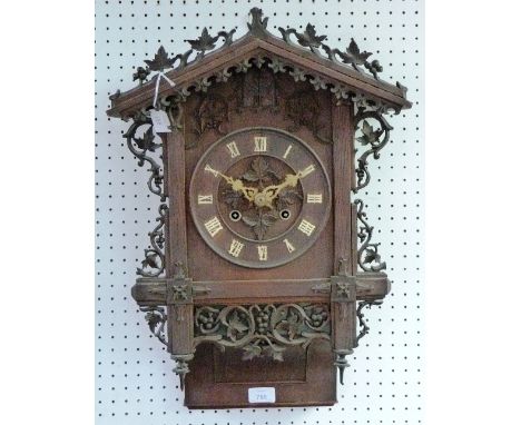A Black Forest Cuckoo Clock, of carved architectural form, the case bearing a label for "Camerer, Kuss, Tritschler & Co, 22in