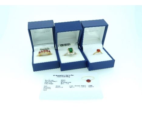 Rocks & Co.; Three Rings, one set cherry fire opal, in yellow gold marked 375 (with certificate card) Size N, one set emerald