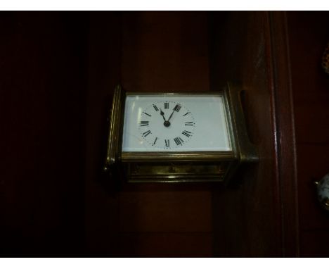 A French gilt brass Carriage Clock, of traditional five-glass form, the white dial with black Roman numerals, 5½in (14cm) hig