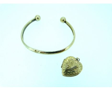 A 9ct yellow gold hinged heart shaped Locket, 2.8g, together with a yellow metal bangle with ball finials 3.6g (2)