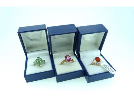 Rocks & Co.; Three Rings, one set orange coloured stone with white sapphire surround, marked 375, Size N, one set pink topaz 