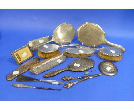 A George V seven-piece silver-backed Toilet set, hallmarked Birmingham, 1929, comprising a hand mirror, two hair brushes, two