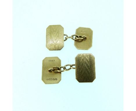 A pair of 9ct oblong cut cornered double sided Cufflinks, with chain between, each face engine turned, approx. total weight 5