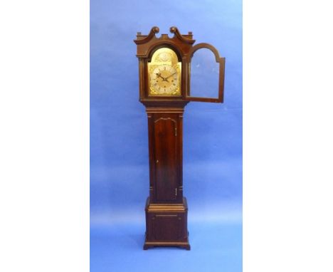 An early 20thC eight day mahogany Grandmother Clock, striking on a bell, the silvered chapter dial with Roman and Arabic nume