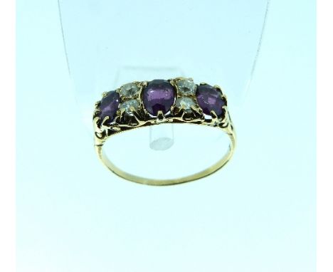 An amethyst and diamond set Ring, the front with three oval amethysts with four small diamonds between, with a carved gallery