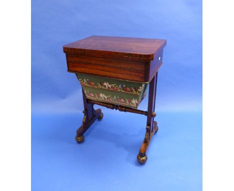 An early 19thC rosewood Games/Sewing Table, the rectangular folding top with tooled red leather inset, above a frieze drawer 