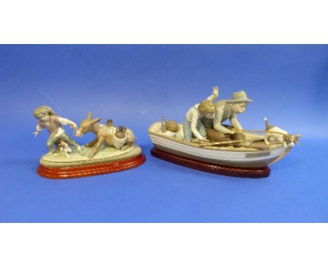 A Lladro porcelain large figurine, No.5215, Fishing with Gramps - on Paloma Boat, with wooden stand, 15in (38cm) long, togeth