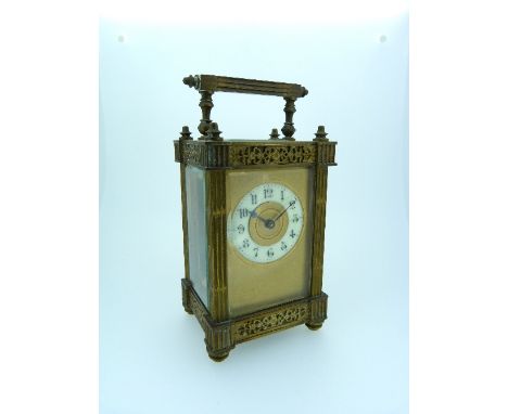 A French gilt brass Carriage Clock, of architectural form with fluted columns, the circular dial with Arabic numerals, 6in (1
