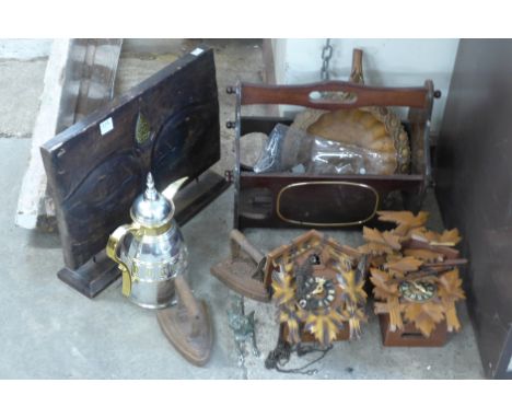 Two cuckoo clocks, wooden centrepiece, brass fox door knocker, two cast iron irons, etc.