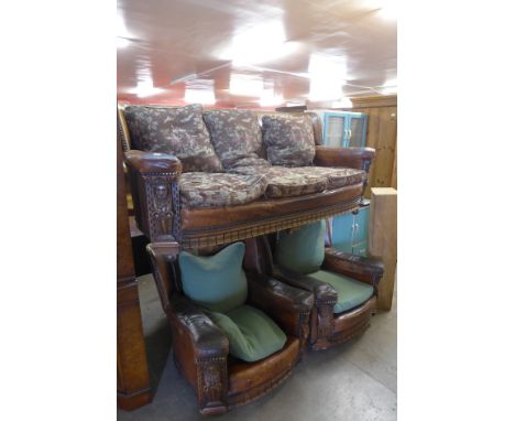 A 1920's carved oak and leather three piece suite