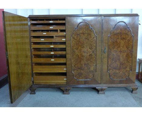 A 1930's mahogany and burr walnut fitted three door bachelors wardrobe, made by Frederick Restall Ltd, Great Hampton St., Bir